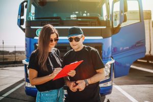 Two,Professional,Truck,Drivers,Stand,In,Front,Of,The,Big